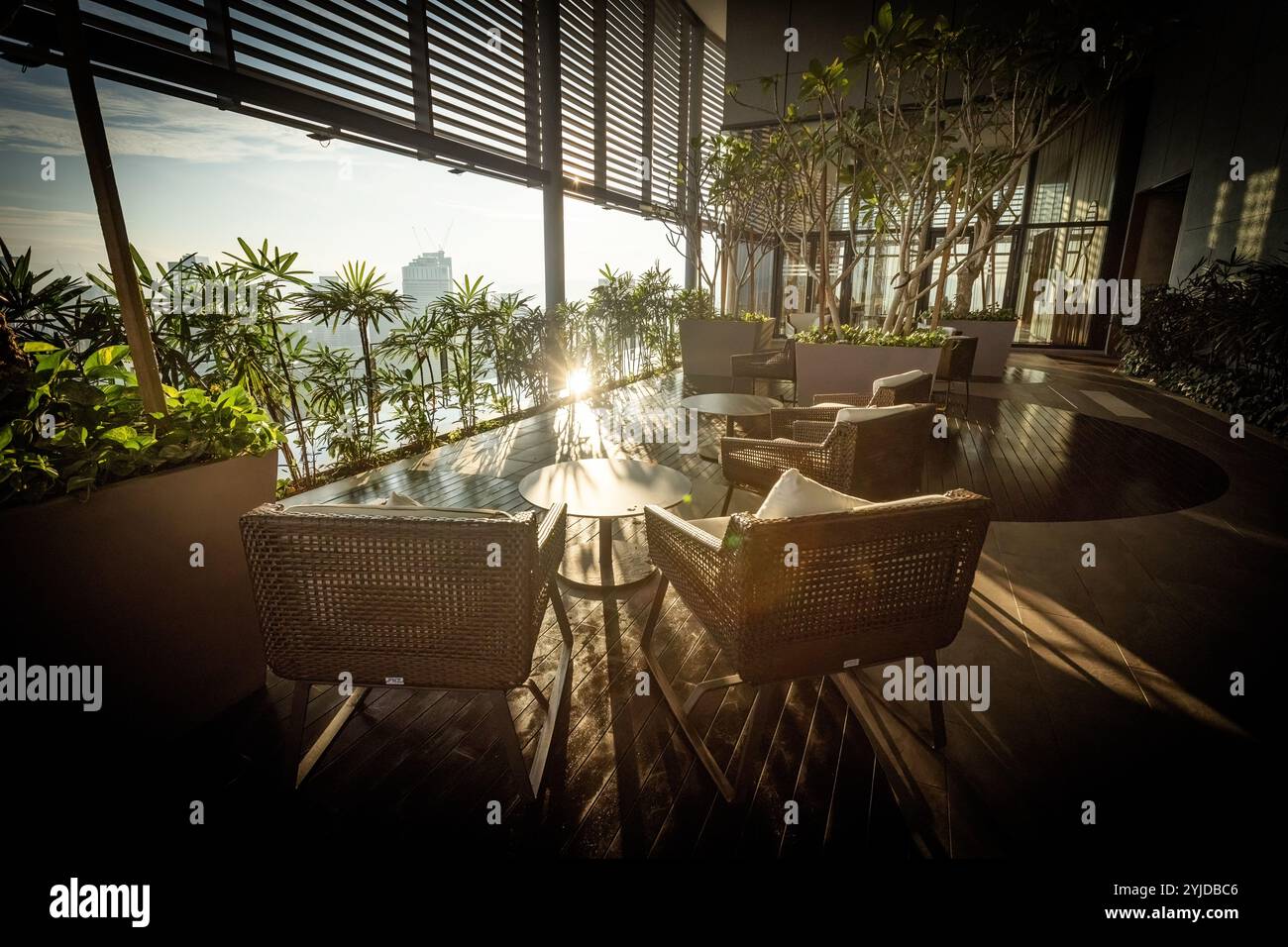 Terrasse auf dem Dach des Luxushotels mit Chill-out-Zone und sonnendurchfluteten Pflanzen Stockfoto