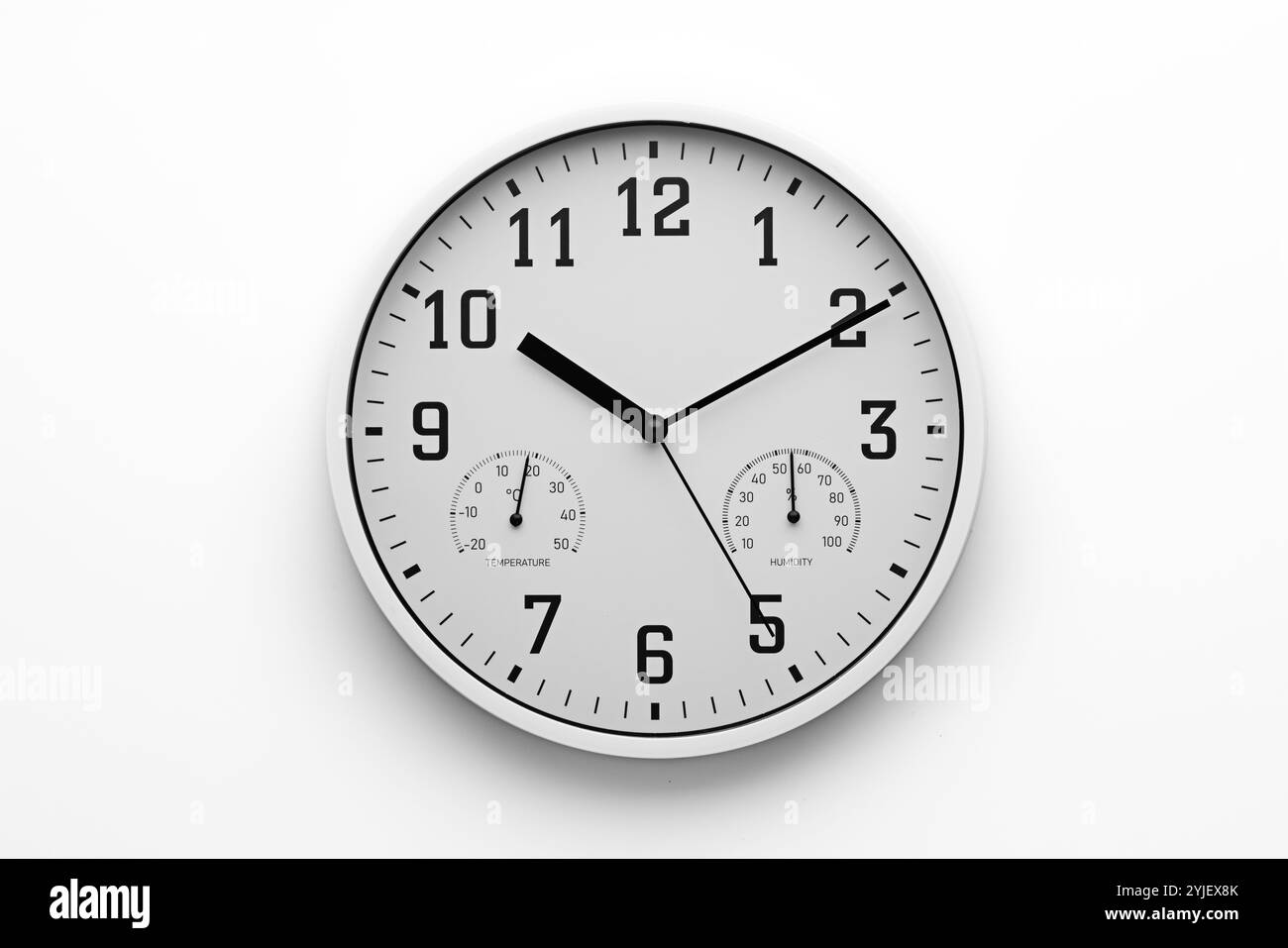 Wanduhr mit Temperatur, Feuchtemessgerät isoliert auf weißem Hintergrund, Konzept für Zeit- und Geschäftsvideos Stockfoto