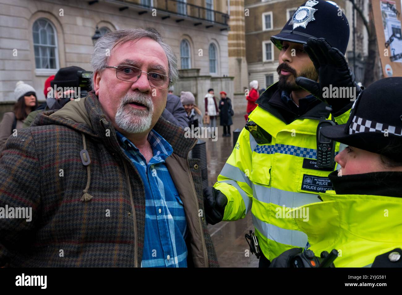 London, Großbritannien. Februar 2018. Polizisten sagen einem Demonstranten, der Whitehall blockiert, dass er den Highway blockiert. März mit den Obdachlosen - #solidaritynotcharity, Streets Kitchen, Obdacheless Outreach Central und London: März für die Obdachlosen blockierten Whitehall in der Downing St, nachdem raue Schläfer in den Straßen von London in der letzten kalten Zeit gestorben sind, um zu sagen, dass genug ist genug - keine Toten mehr auf unseren Straßen. Sie sagen, dass die Regierung ihrer Pflicht nicht nachkommt, Sozialwohnungen bereitzustellen und ihre Bürger zu plündern, und dass staatliche Kürzungen bei Sozialleistungen und Geldern für Sozialdienstleistungen töten Stockfoto