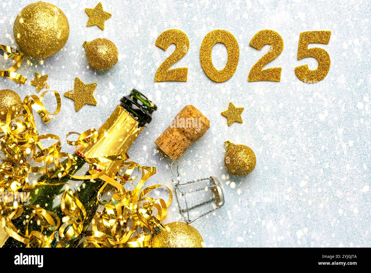 Flasche Champagner mit goldenen weihnachtskugeln, goldenen Sternen und 2025 in goldenen Zahlen auf einem schneebedeckten Hintergrund. Silvesterfeier Konzept Hintergrund Stockfoto