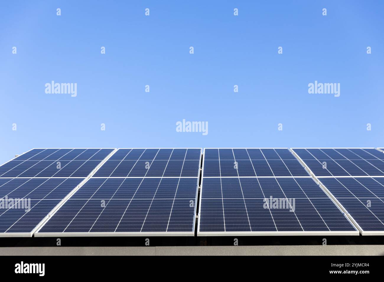 Luftaufnahme von Solarzellen auf klarem blauem Himmelhintergrund. Sauberes Konzept für alternative Energie, nachhaltige Ressourcen. Modernes Haus, Solarscheibe Stockfoto
