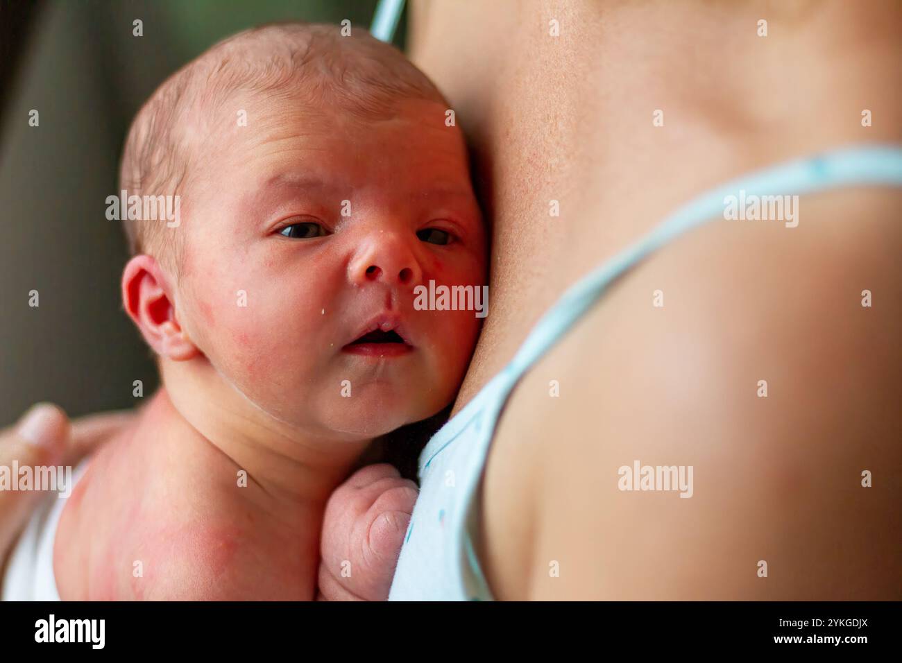 Schlafendes Baby, das nach der Pflege friedlich auf der Brust der Mutter ruht Stockfoto