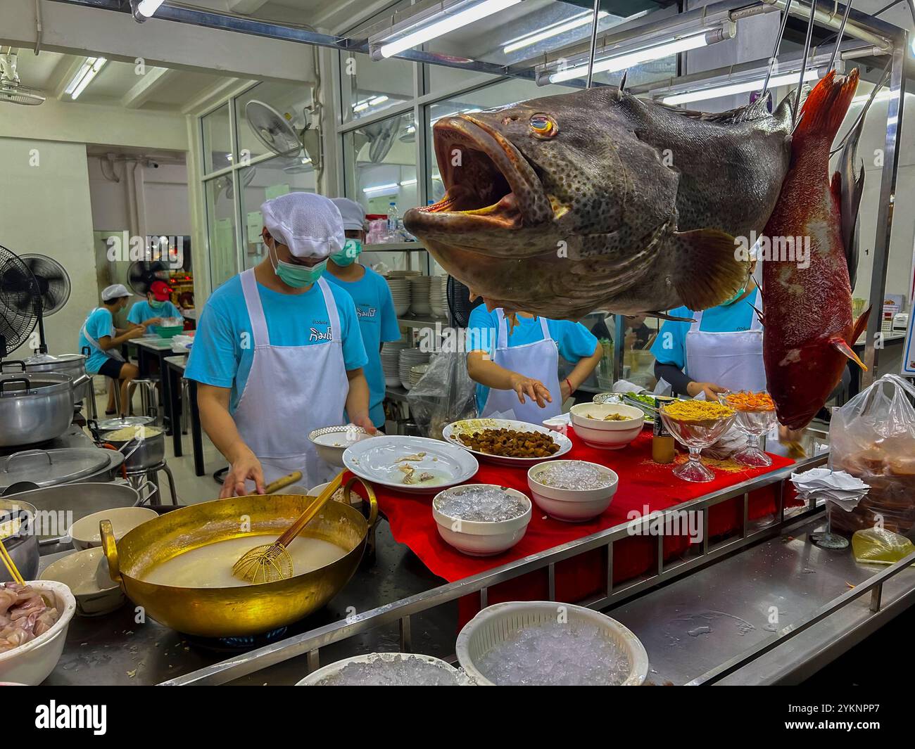 Bangkok, Thailand, Menschen, Männer, Thailändische Köche, Zubereitung von Tellern in der Küche, draußen, Nacht, Thai Restaurant, Street Food , Anbieter, Fisch Stockfoto