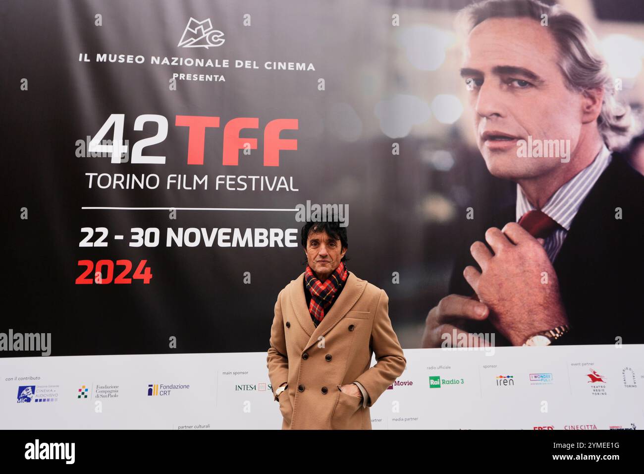 Torino, Italien. November 2024. IL direttore artistico del Torino Film Festival Giulio Base il posa in fronte al Manifesto del 42&#xb0; Torino Film Festival. - 21. November 2024. (Foto: Fabio Ferrari/LaPresse) Credit: LaPresse/Alamy Live News Stockfoto