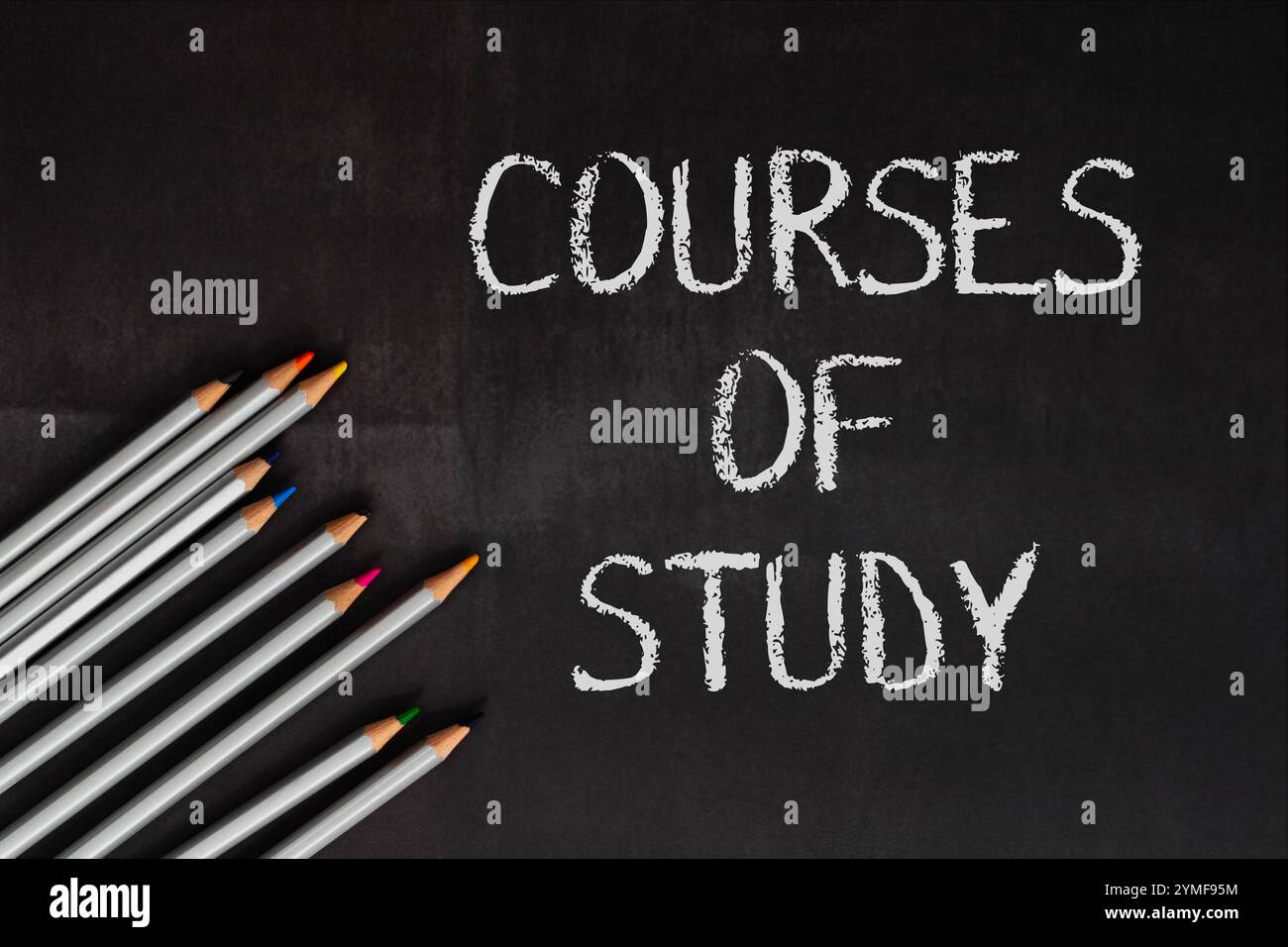 Ein Schwarzes Brett mit dem Wort „Kurse des Studiums“. Die Tafel ist mit Bleistiften bedeckt, von denen einige farbig sind Stockfoto