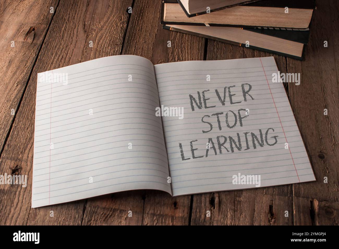 Hören Sie nie auf zu lernen. Dies ist eine Erinnerung daran, weiter zu lernen und zu wachsen. Ein Notizbuch, das zu einer Seite geöffnet ist und auf dem die Wörter „Never Stop Learning“ geschrieben sind. Die Stockfoto