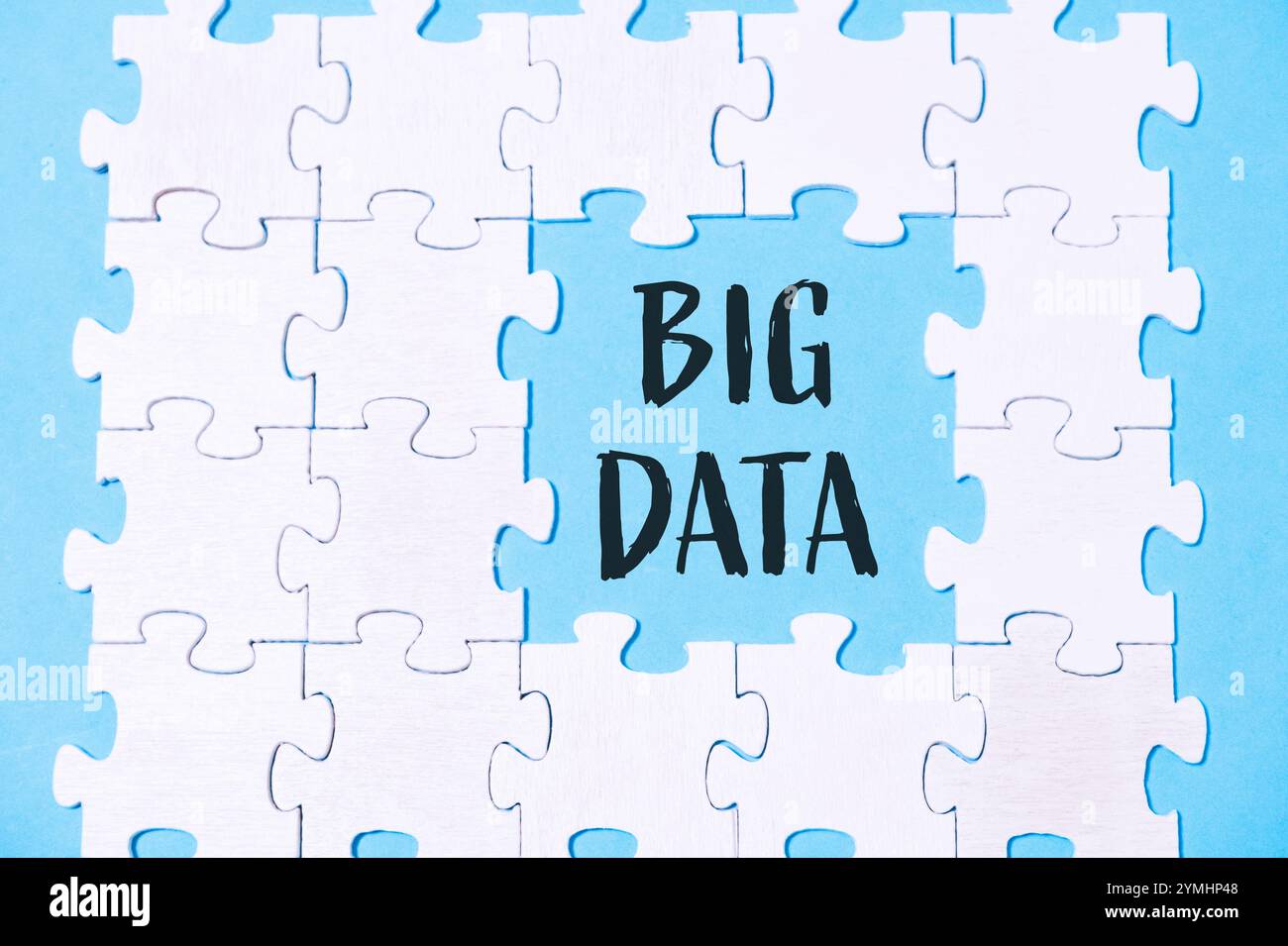 Puzzle mit dem Wort Big Data in der Mitte. Das Puzzle besteht aus weißen Teilen und ist auf blauem Hintergrund Stockfoto