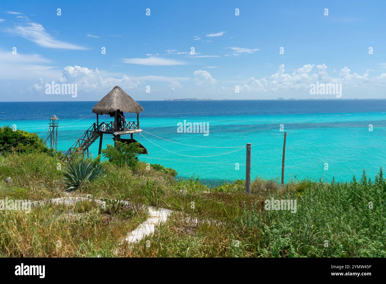 Rustikale tropische Hütte mit Panoramablick auf das türkisfarbene Karibische Meer in Isla Mujeres, Mexiko an einem sonnigen Tag. Exotisches und entspannendes Reiseziel Stockfoto