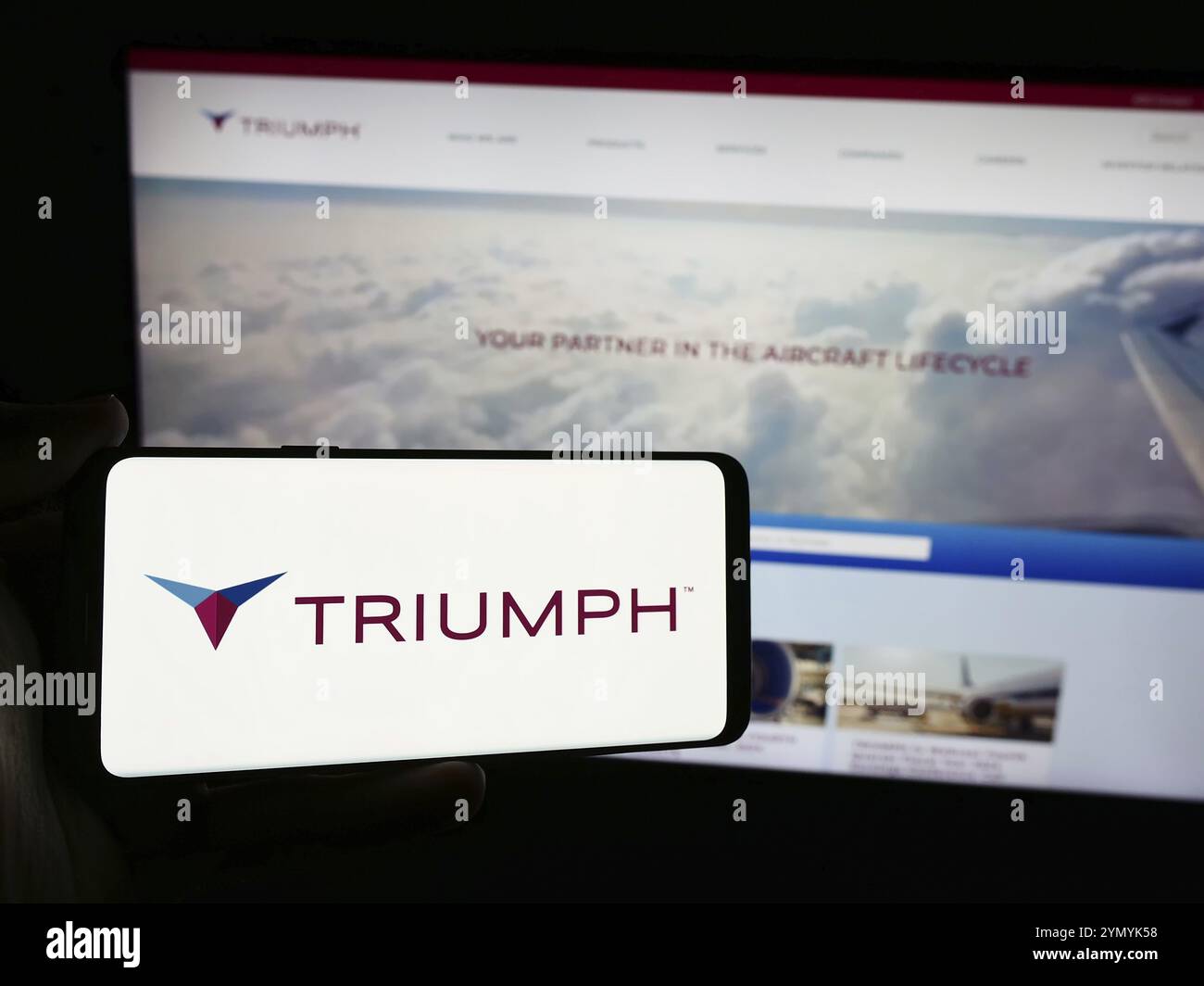 Stuttgart, Deutschland, 07.08.2024: Person, die ein Smartphone mit dem Logo des US-amerikanischen Luftfahrtunternehmens Triumph Group Inc. Vor der Website hält. Konzentrieren Sie sich auf die Telefondiskretion Stockfoto