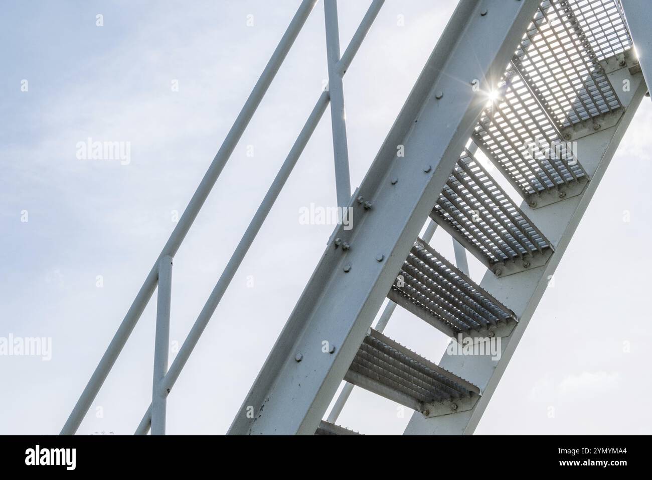 Stahltreppe mit Stufen aus perforiertem Blech gegen das Licht Stockfoto