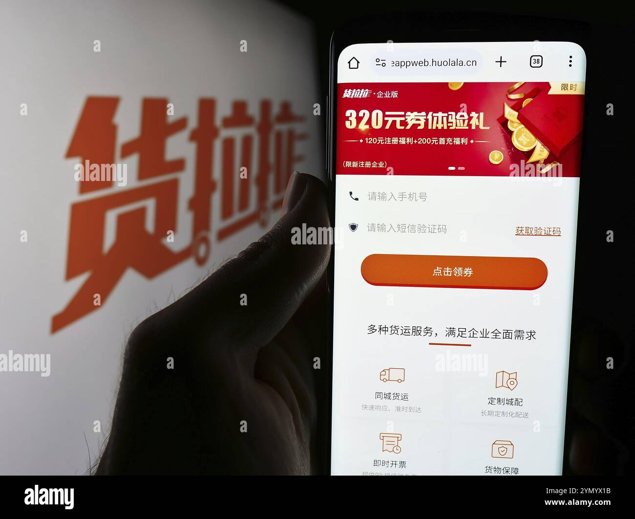 Stuttgart, Deutschland, 17.05.2024: Person, die ein Smartphone hält, mit Webseite des chinesischen Logistikplattformunternehmens Huolala vor dem Logo. Konzentrieren Sie sich auf die Mitte Stockfoto