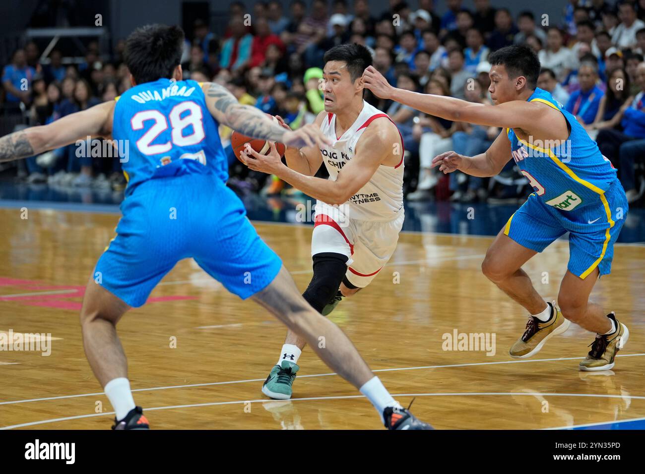 Hong Kong's Tsai Choi Kwan, center, tries to go past Philippines' Kevin ...