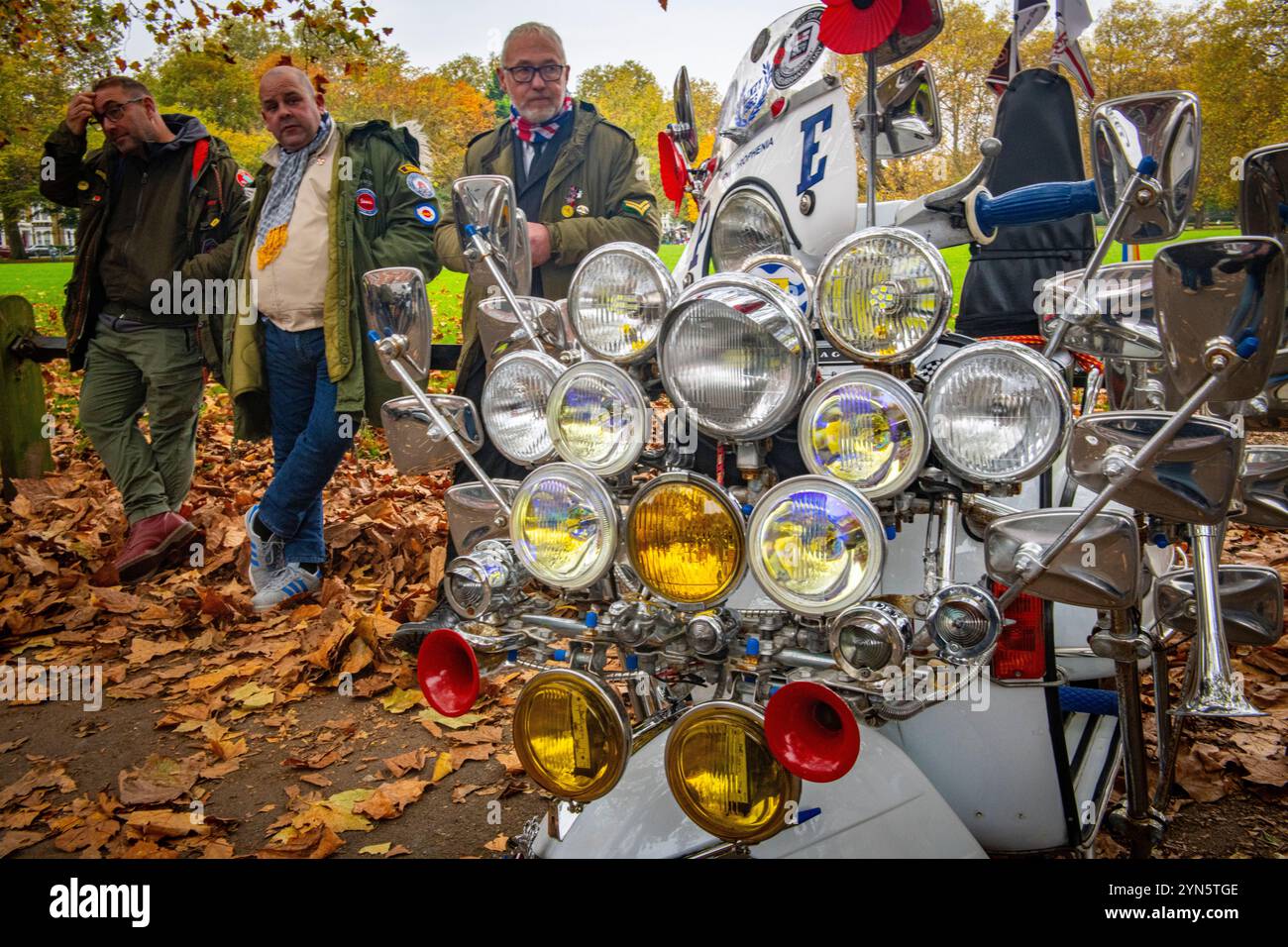 Scheinwerfer schmücken Mods' Roller auf der Fahrt von Remembrance für Mods und Scooteristen in Erinnerung an diejenigen, die im Krieg ihr Leben verloren haben. Stockfoto