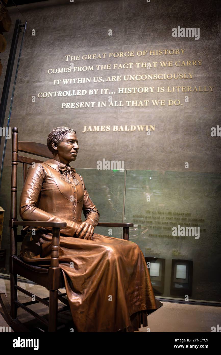 Clara Brown Statue National Museum of African American History Washington DC // WASHINGTON DC – Eine Bronzestatue von Clara Brown, bekannt als „Tante Clara“, markiert den Eingang zum National Museum of African American History and Culture, der Ausstellung zur Ära der Segregation. Die sitzende Figur erinnert an Browns Rolle als bahnbrechende afroamerikanische Geschäftsfrau im Colorado-Territorium nach ihrer Emanzipation. Die Statue stellt die Ausstellung des Museums über das afroamerikanische Leben von 1877 bis 1968 vor. Stockfoto