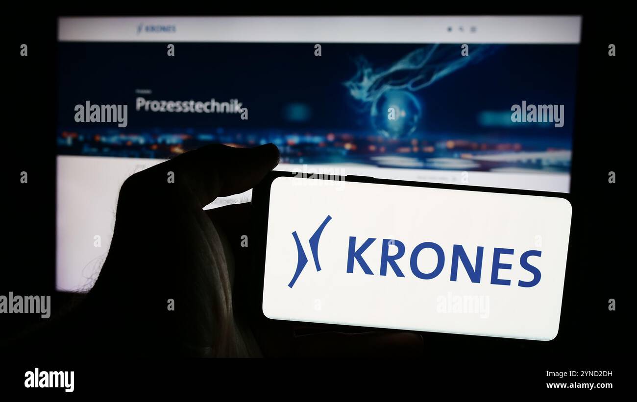 Deutschland. August 2024. In dieser Fotoabbildung hält eine Person ein Mobiltelefon mit dem Logo des deutschen Ingenieurunternehmens Krones AG vor der Business-Webseite. (Foto von Timon Schneider/SOPA Images/SIPA USA) *** ausschließlich für redaktionelle Nachrichten *** Credit: SIPA USA/Alamy Live News Stockfoto