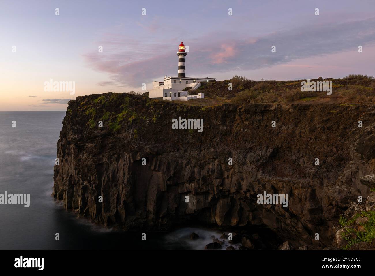 Am nordwestlichen Rand der Insel Graciosa steht der malerische Leuchtturm Ponta da Barca neben einer Reihe von Meeresstapeln und Inselchen, darunter eine Stockfoto