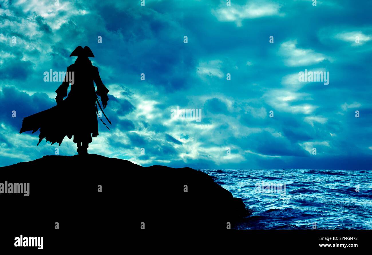 silhouette of a pirate standing on the top of a ridge looking at the sea Stockfoto