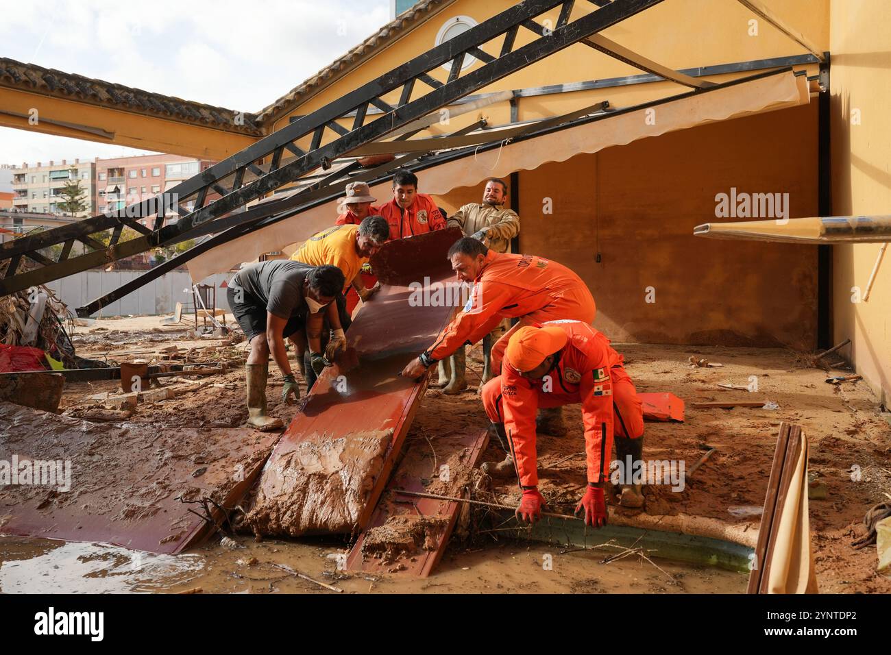 Picaña, Spanien - 26. November 2024. Die „Brigada de Rescate Topos Tlatelolco“ ist eine Bürgervereinigung, die sich aus erfahrenen Helfern mit professioneller Ausbildung und Erfahrung zusammensetzt und sich für Hilfe und Hilfe für Menschen in Not in Gebieten engagiert, die von Naturkatastrophen wie Erdbeben, Überschwemmungen und Hurrikanen und verschiedenen Unfällen betroffen sind. Die sind ein erste-Hilfe-Team, in diesem Fall helfen sie bei der Reinigung eines Hauses am Rande der Schlucht von Poyo (Barranco el Poyo) vor einer der drei Brücken, die am 29. Oktober vom Wasserstrom gefegt wurden. Quelle: Roberto Arosio/Alamy Live News Stockfoto