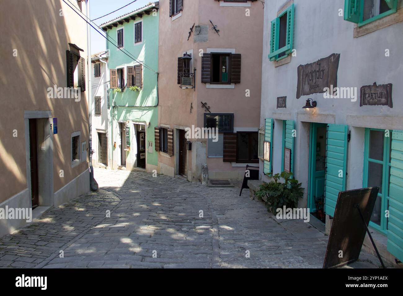 Kopfsteinpflasterallee gesäumt von Geschäften in der historischen Stadt Motovun, Kroatien Stockfoto