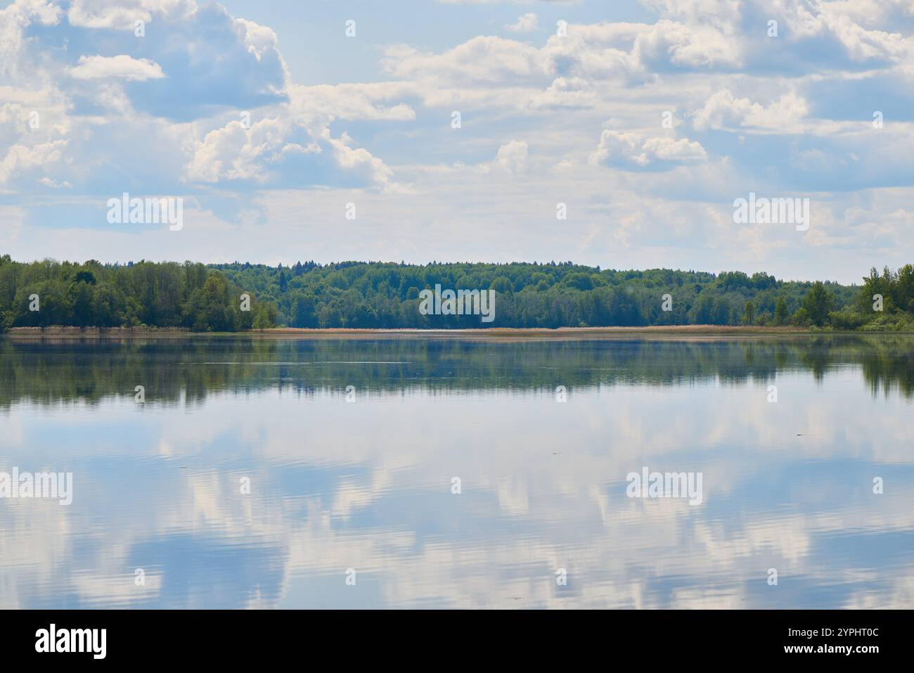 Erleben Sie die ruhigen Reflexionen am See, die wunderschön unter einem sanft bewölkten Himmel gemalt wurden Stockfoto