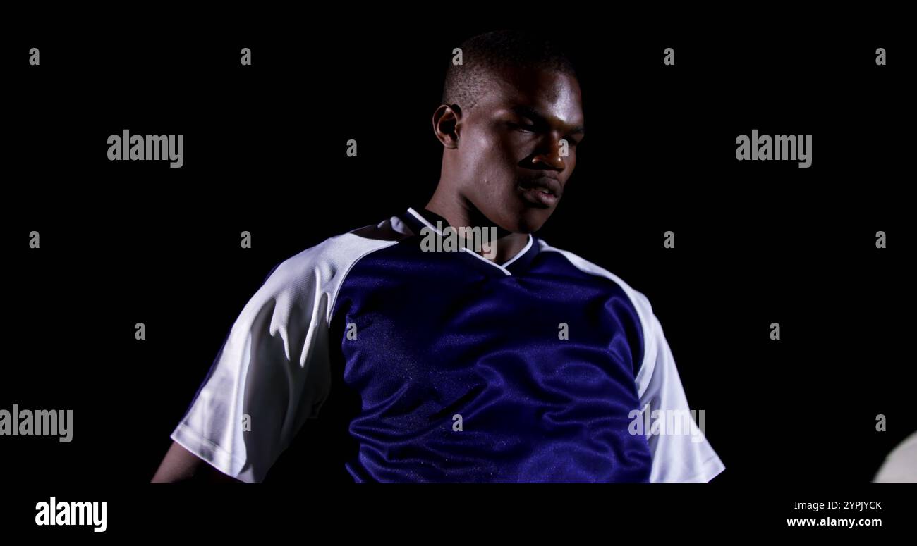 Selbstbewusster Fußballspieler, der auf dem Spielfeld Ball jongliert Stockfoto