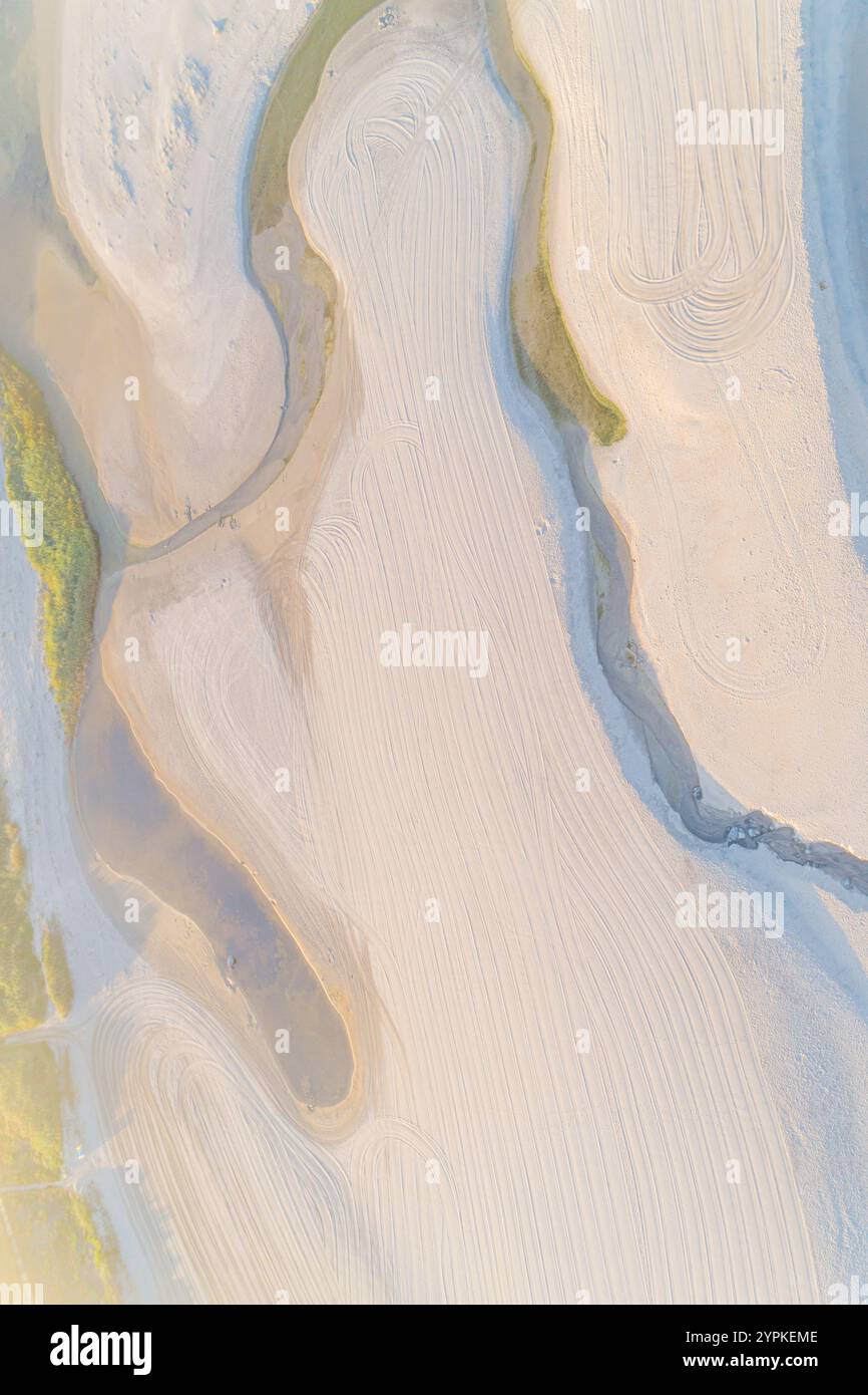 Zenithaler Luftblick auf einen Strand mit einem kleinen Bach, der ins Meer fließt, Drohnenfotografie Stockfoto