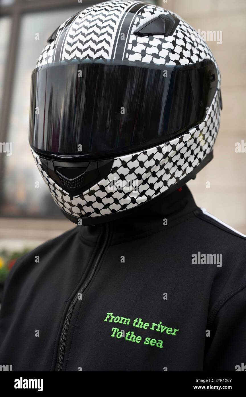 Am 30. November 2024 verlangten Tausende Demonstranten einen Waffenstillstand in Gaza. Helm mit Keffiyeh-Muster. Stockfoto