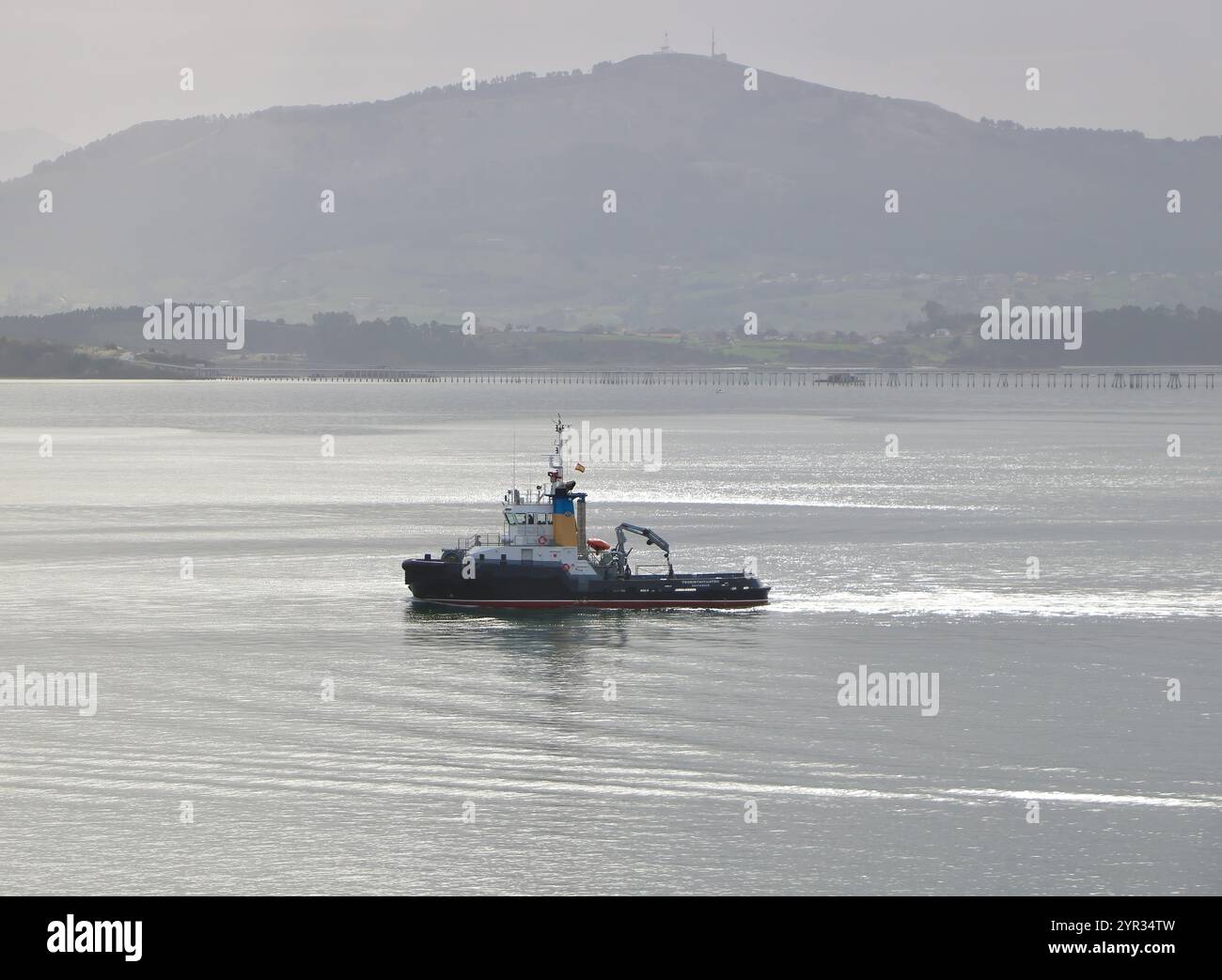 Spanisch Tug Trheintaycuatro in der Bucht von Santander Cantabria Spanien fährt an einem ruhigen Herbsttag auf ein eintreffendes Schiff Stockfoto