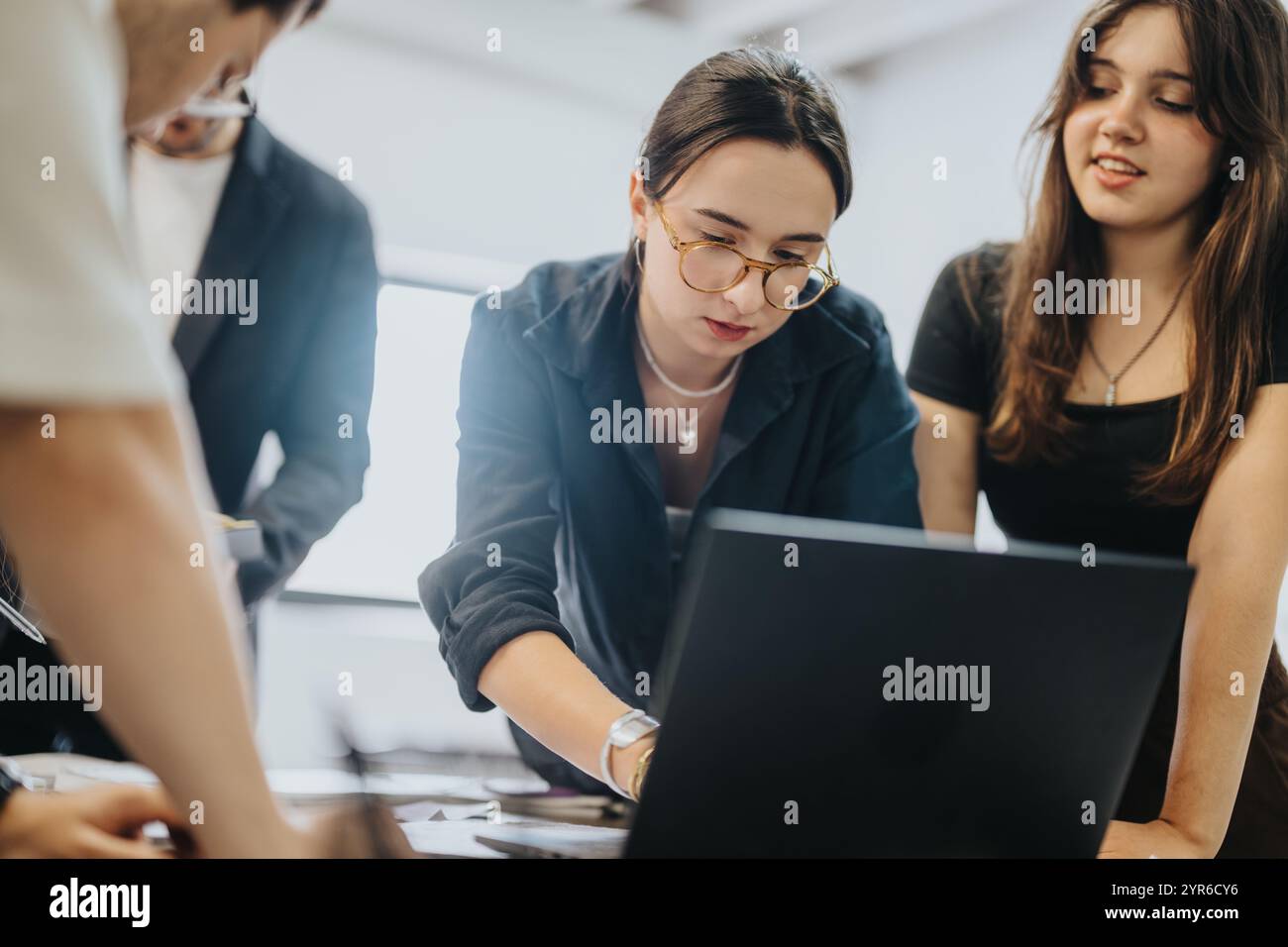 Schüler, die mit einem Laptop an Schulaufgaben arbeiten Stockfoto