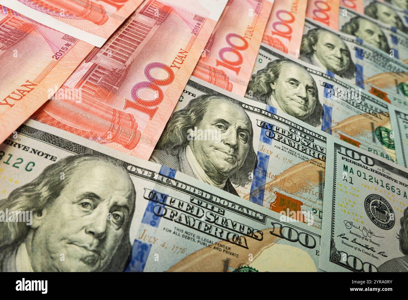 Dollarscheine des US-Dollar und des chinesischen Yuan ruhten gegeneinander und schilderten die Konfrontation zwischen zwei wirtschaftlichen und politischen Systemen. Dollar. Yuan. Mo Stockfoto