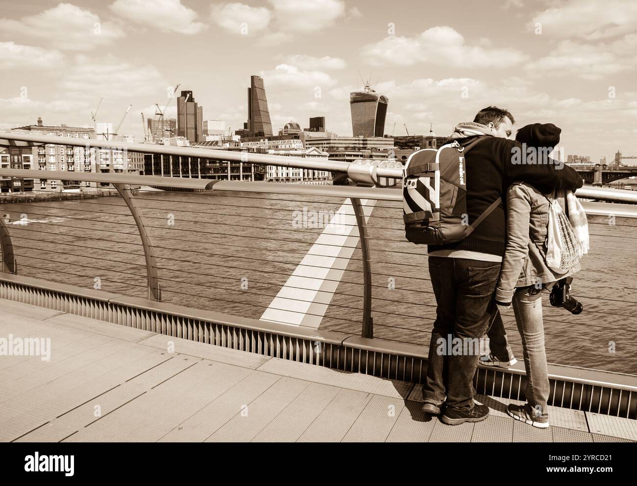 LONDON, ENGLAND, Großbritannien - 3. MAI 2014: Touristen, die von der Millennium Bridge aus auf das Stadtbild schauen. Historisches Foto von Sepia. Stockfoto