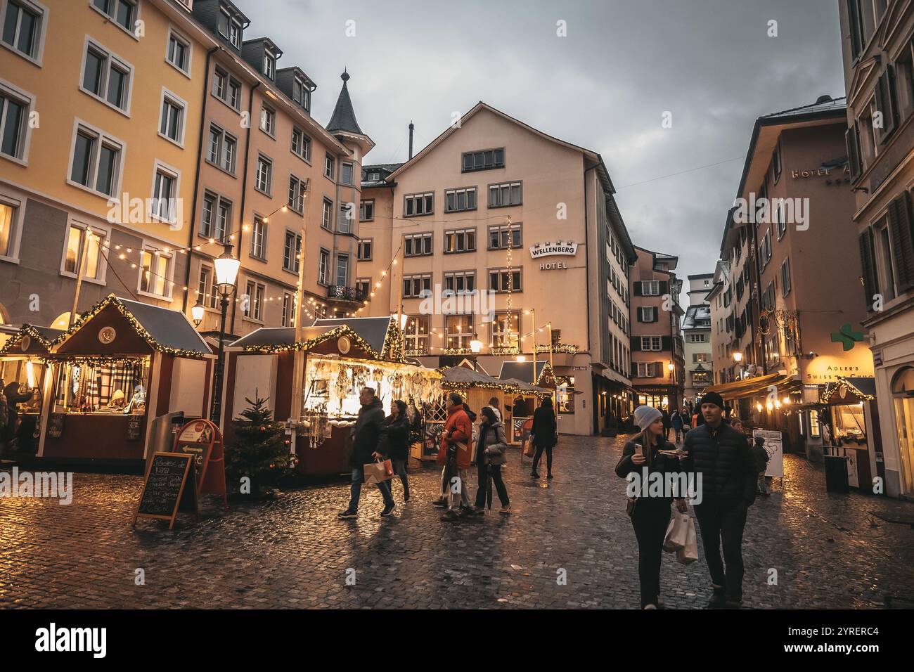 Eine lebendige Szene der Weihnachtsmärkte in Zürich mit festlicher Dekoration, Lichtern und belebten Straßen, die den Feiertagsgeist der Stadt einfangen. Stockfoto