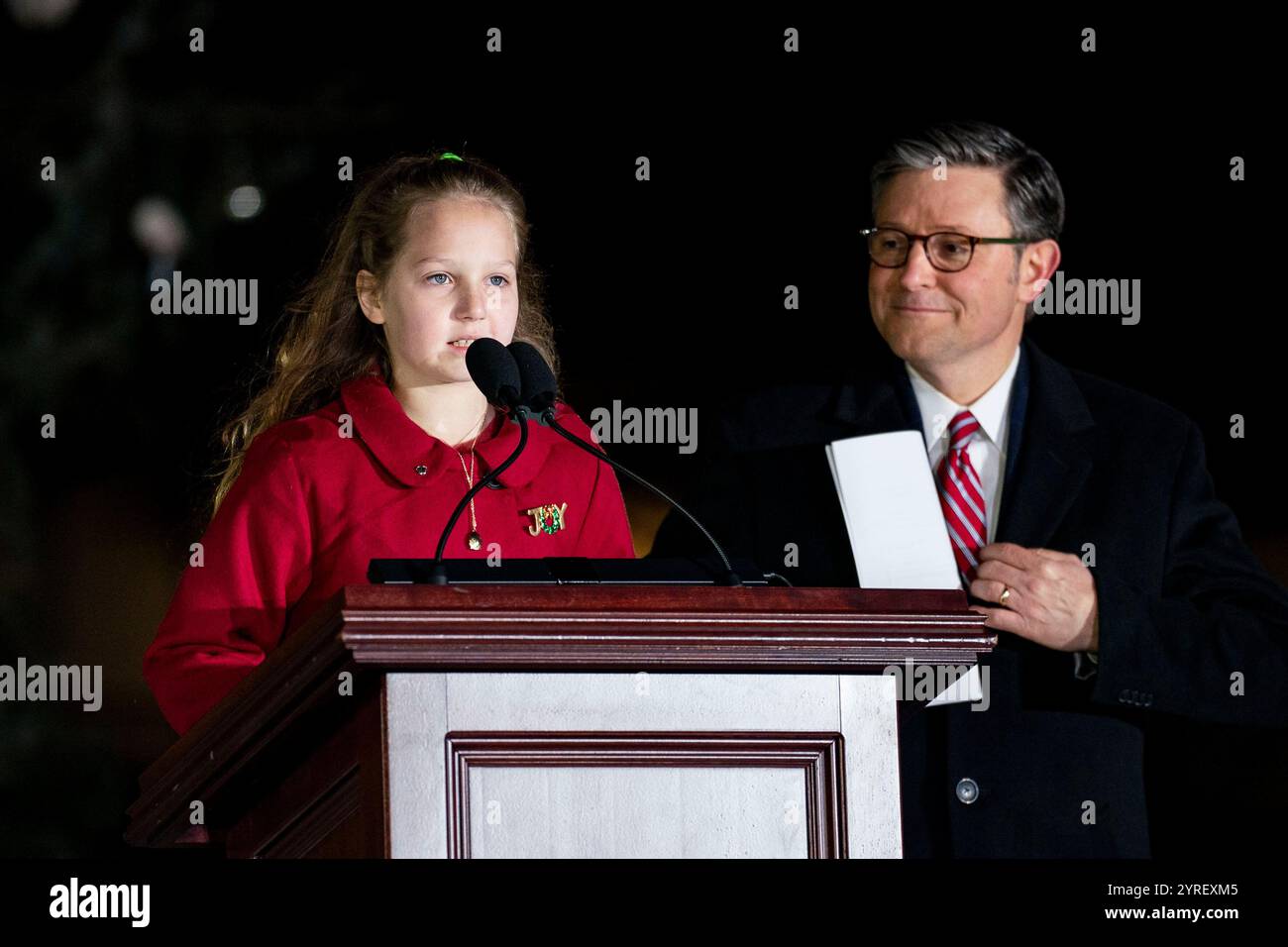Washington, Usa. Dezember 2024. Der Sprecher des House Mike Johnson, R-LA, sieht auf AS.Jugendbaumfeuer Rose Burke, eine viertklassige Schülerin aus Kenai, Alaska, spricht während einer Zeremonie mit der Delegation des Alaska-Kongresses und dem Gouverneur von Alaska Mike Dunleavy, um den Weihnachtsbaum des US-Kapitols am Dienstag, den 3. Dezember 2024 auf dem Westfront Rasen des US-Kapitols in Washington, DC, anzuzünden. Der Baum, eine 80 Meter hohe Sitka-Fichte aus dem Tongass National Forest, ist der zweite National Christmas Tree aus Alaska. Foto: Bonnie Cash/UPI Credit: UPI/Alamy Live News Stockfoto