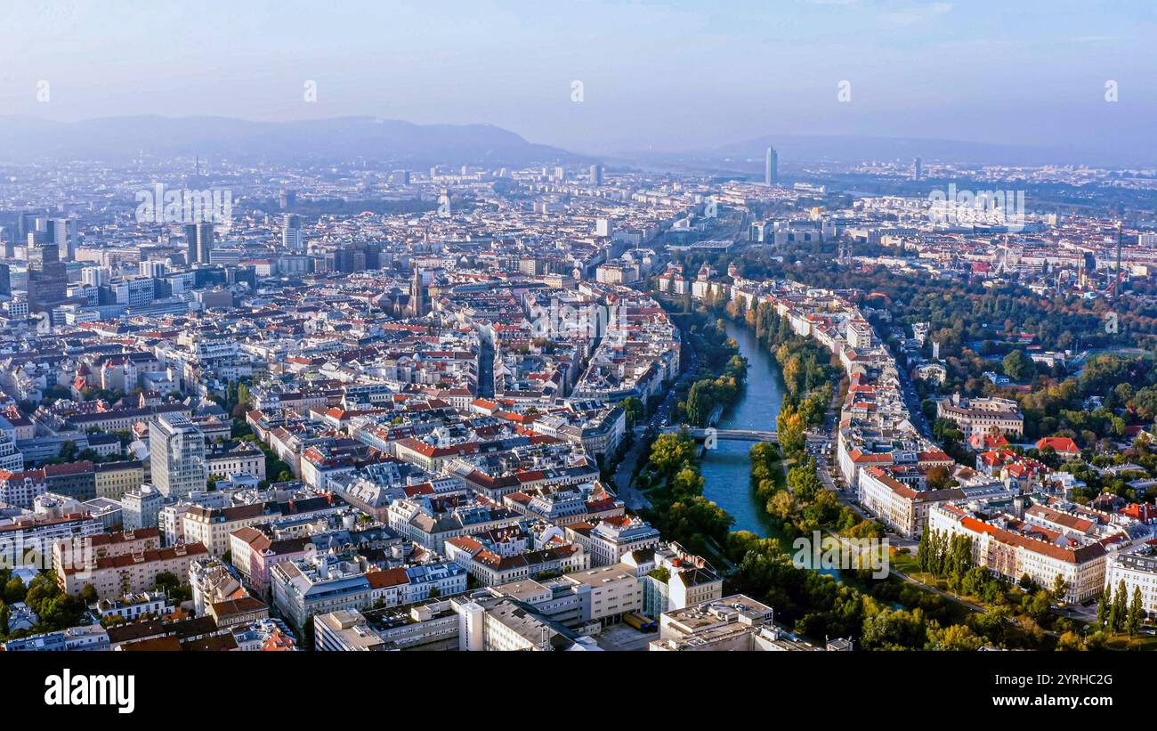 Atemberaubender Blick aus der Luft auf Wien, Österreich, mit der historischen Stadtlandschaft, dem ruhigen Donaukanal und berühmten Wahrzeichen unter klarem Himmel. Stockfoto
