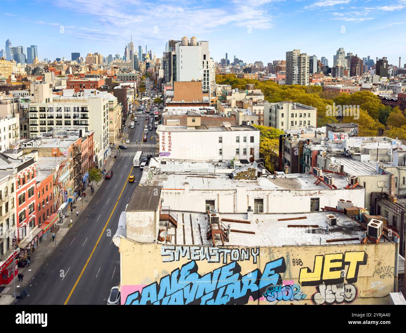 Lebhafter Blick aus der Luft auf bowery chinatown New York City mit Graffiti-Kunst auf Dächern und dem Empire State Building im Hintergrund an klaren Tagen - Smartphone-aufgenommenes Stockfoto