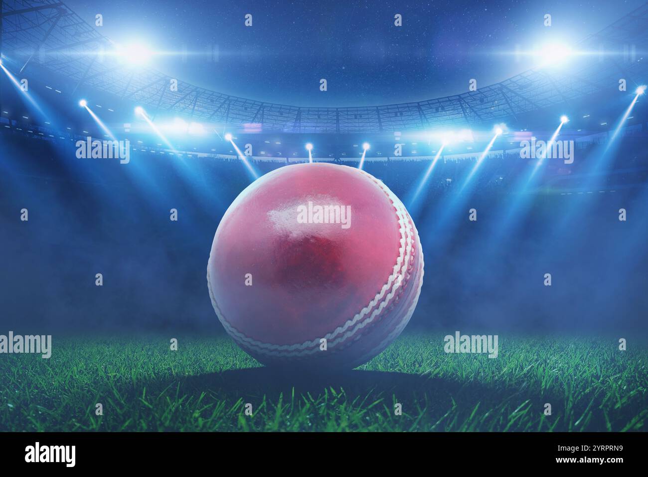 Der rote Cricketball aus Leder liegt im Stadion mit blauen Flutlichtern während des Cricketturniers auf dem Gras. Cricket Championship, kreative Idee Stockfoto