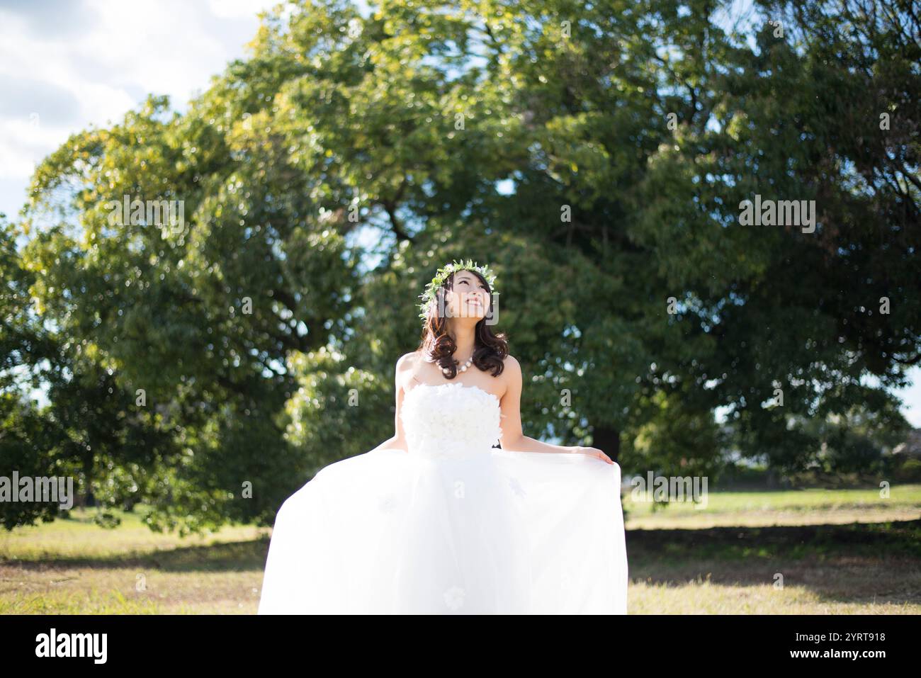 Eine Frau in einem Hochzeitskleid, die ihr Kleid ausbreitet Stockfoto