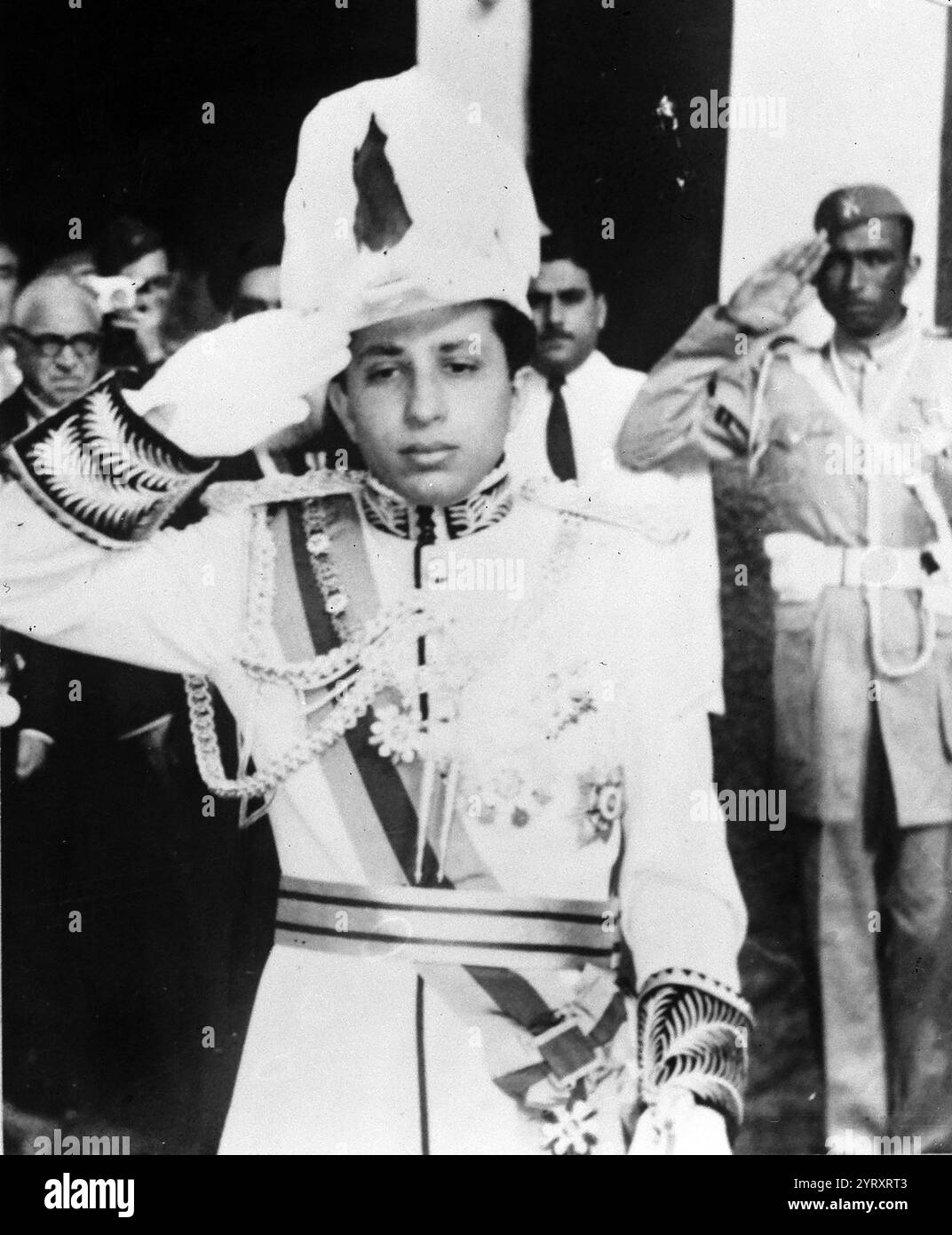König Faisal II. Auf einem Erinnerungsfoto vor seiner Mutter, Königin Alia, im Al Rehab Palast in Bagdad. Faisal II (1935 ? 14. Juli 1958) war der letzte König des Irak. Er regierte vom 4. April 1939 bis zum Juli 1958, als er während der Revolution vom 14. Juli getötet wurde. Dieser Regizid markierte das Ende der siebenunddreißig Jahre alten Haschemitischen Monarchie im Irak, die dann zur republik wurde. Stockfoto