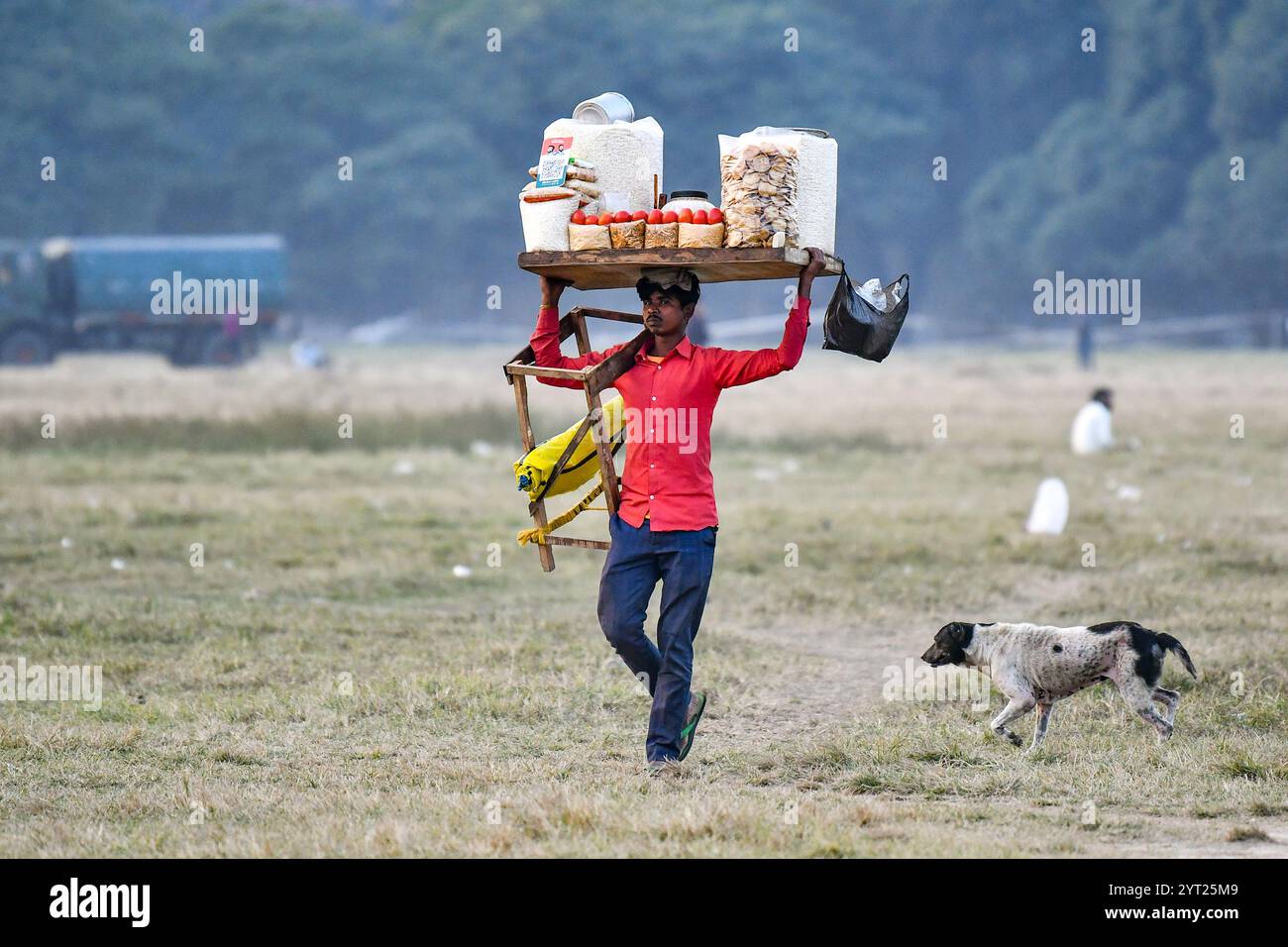 Ein Straßenverkäufer, der durch das Gebiet Maidan, einen städtischen Park von Kalkutta, spaziert. Stockfoto