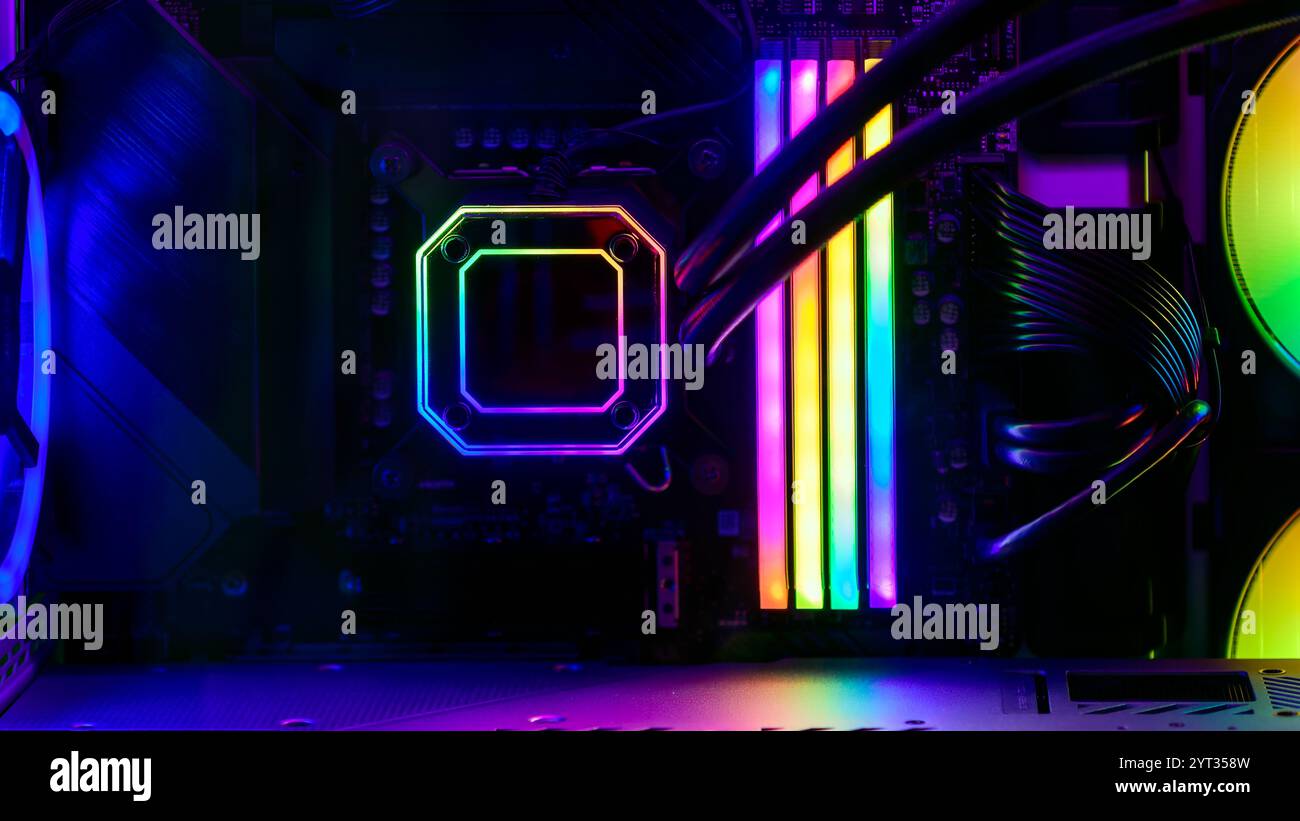 Nahaufnahme eines modernen Gaming-PCs in einem Glasgehäuse mit RGB-Strahlspeicher und CPU-Wasserkühlung Stockfoto