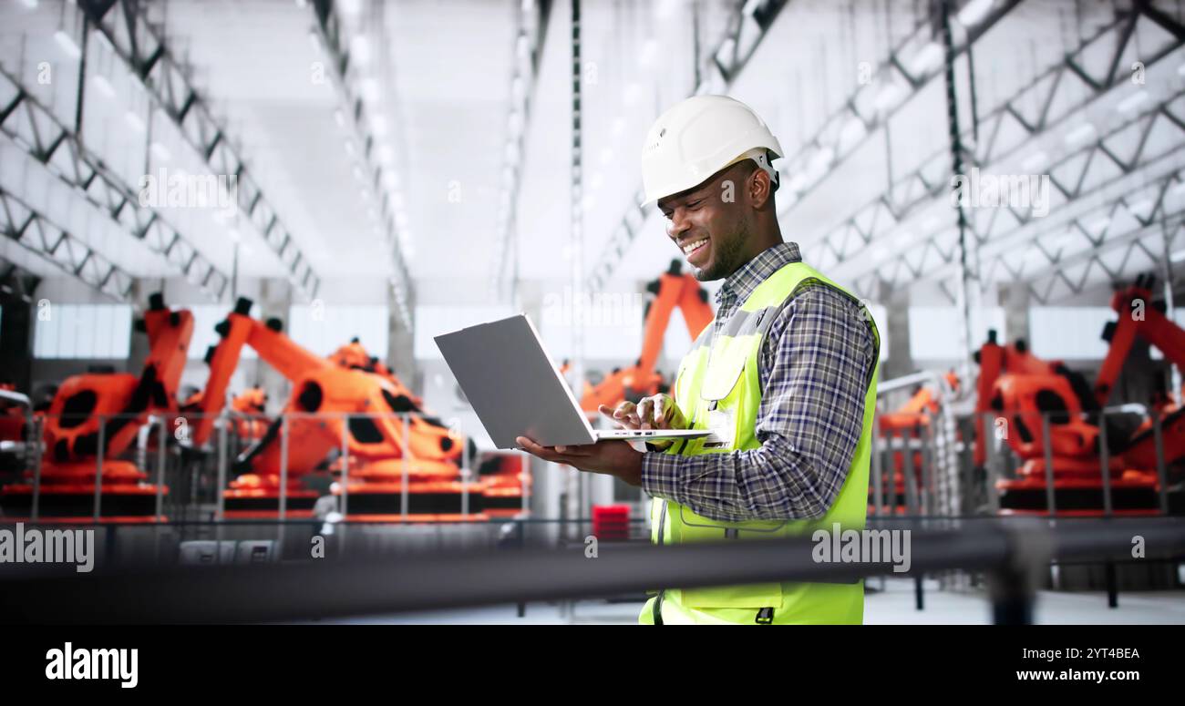Arbeiter In Der Automobilfabrik Mit Laptop Stockfoto
