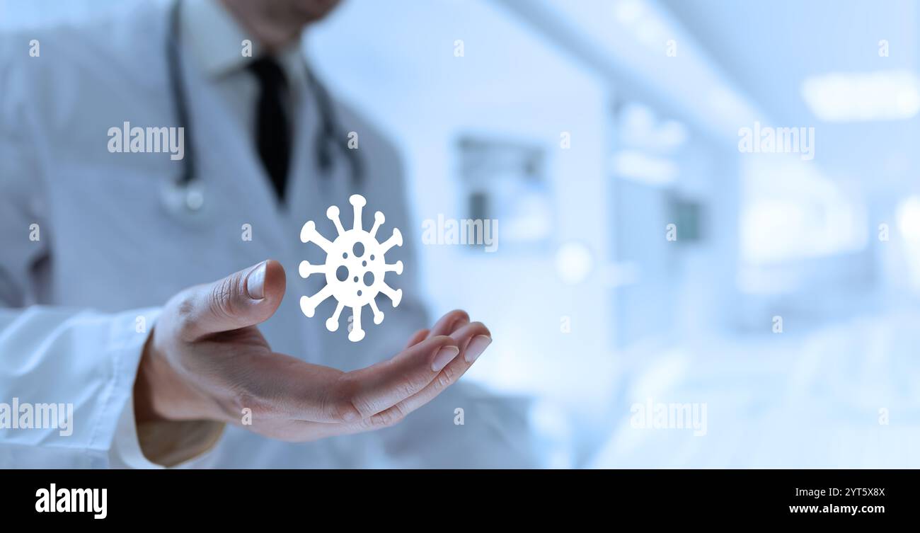 Ein Arzt öffnet seine Handfläche und enthüllt ein Virussymbol, das den Kampf gegen Infektionskrankheiten symbolisiert Stockfoto