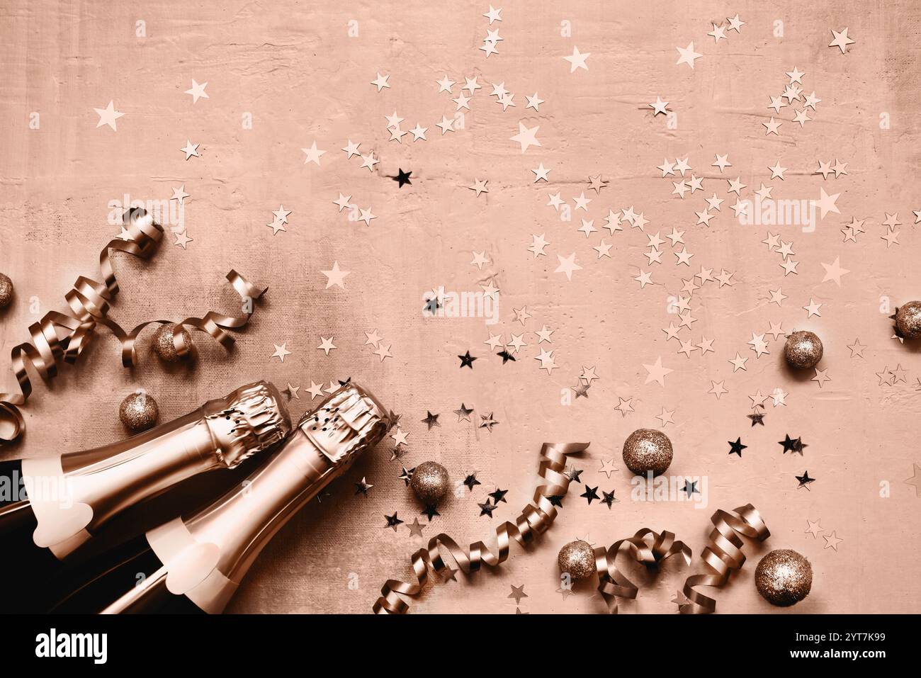 Zwei Champagnerflaschen und Konfetti mit goldenem Stern in braunem Mokka-Mousse-Hintergrund. Flache Lagen von Weihnachten, Neujahr, Purim-Feier-Konzept Stockfoto