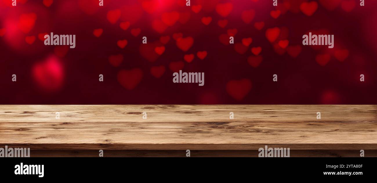 Panorama mit Fliegenden Roten Herzen vor einem leeren Tisch für Valentines Tag Stockfoto