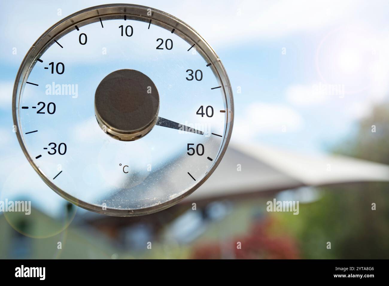 Heißer Sommertag mit 45 Grad und blauem Himmel. Saisonaler Hintergrund mit Thermometer. Hitzewelle. Nahaufnahme mit kurzer Schärfentiefe. Stockfoto