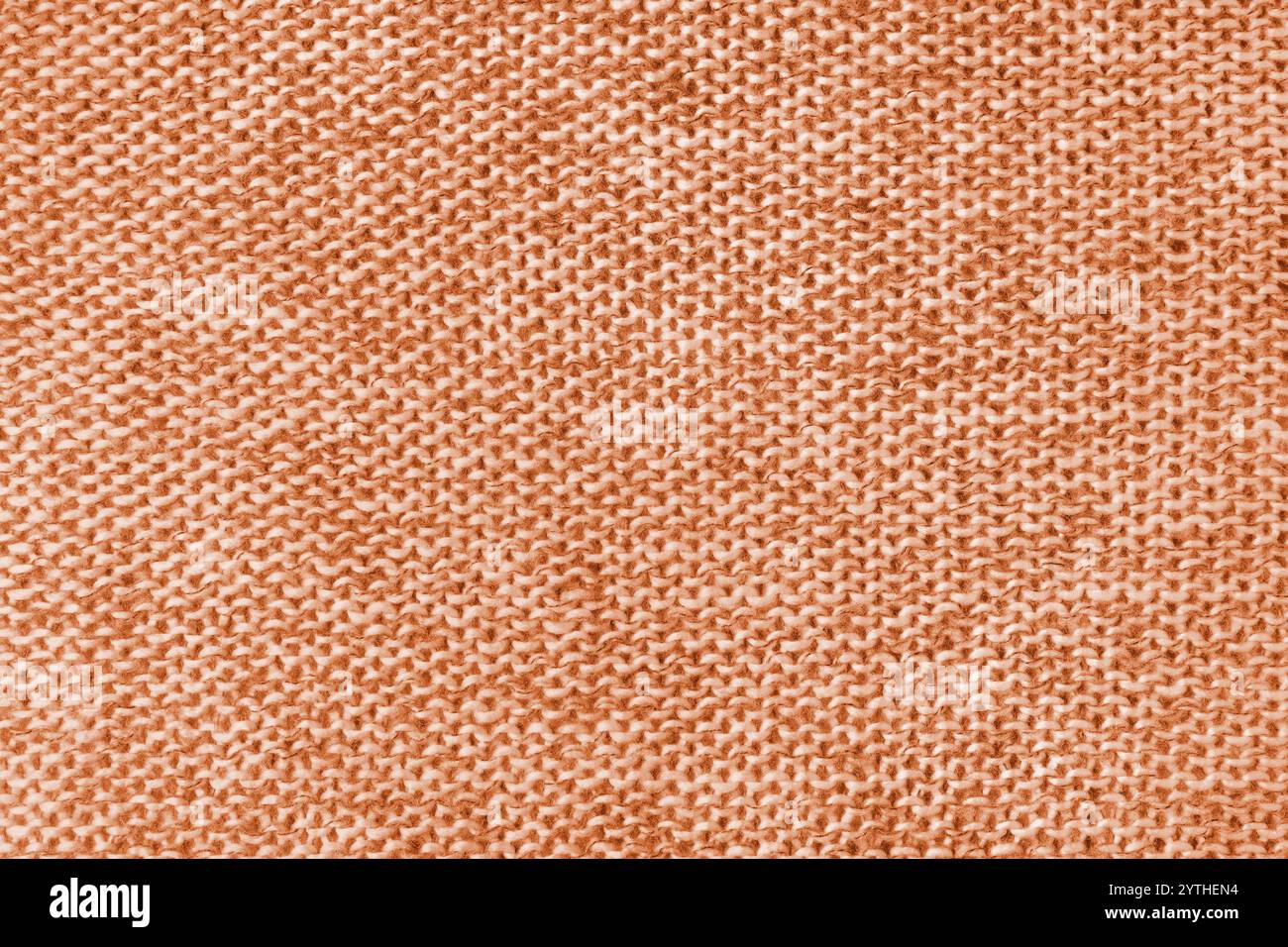 Gemischter weißer und orangener gestrickter Stoff, Kaschmir-Wollstoff-Textur. Hintergrund von Strickgewebe, Jersey-Textil-Struktur, Tuchoberfläche, Stockfoto