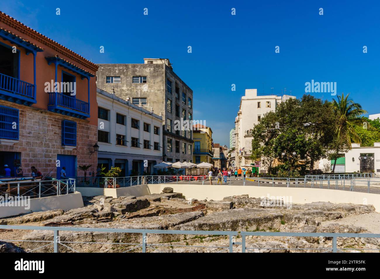 Eine Stadtstraße mit einem großen Gebäude im Hintergrund. Die Straße ist leer und der Himmel ist klar Stockfoto