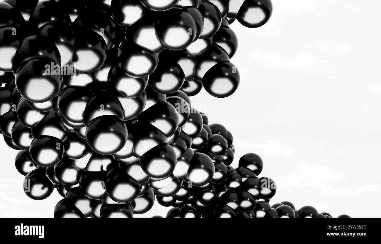 Ein monochromes Bild mit einer Gruppe glänzender schwarzer Kugeln vor hellem Hintergrund. Stockfoto