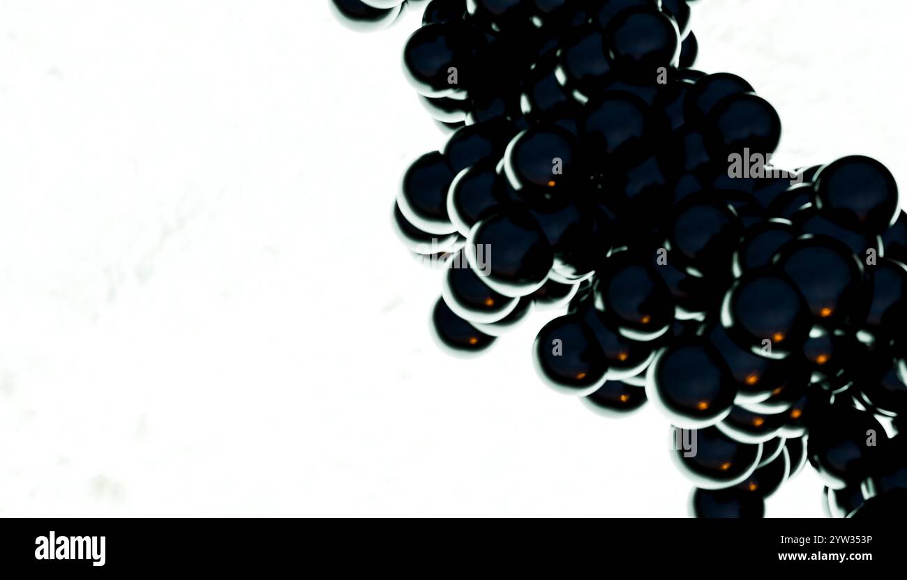 Ein monochromes Bild mit einer Gruppe glänzender schwarzer Kugeln vor hellem Hintergrund. Stockfoto