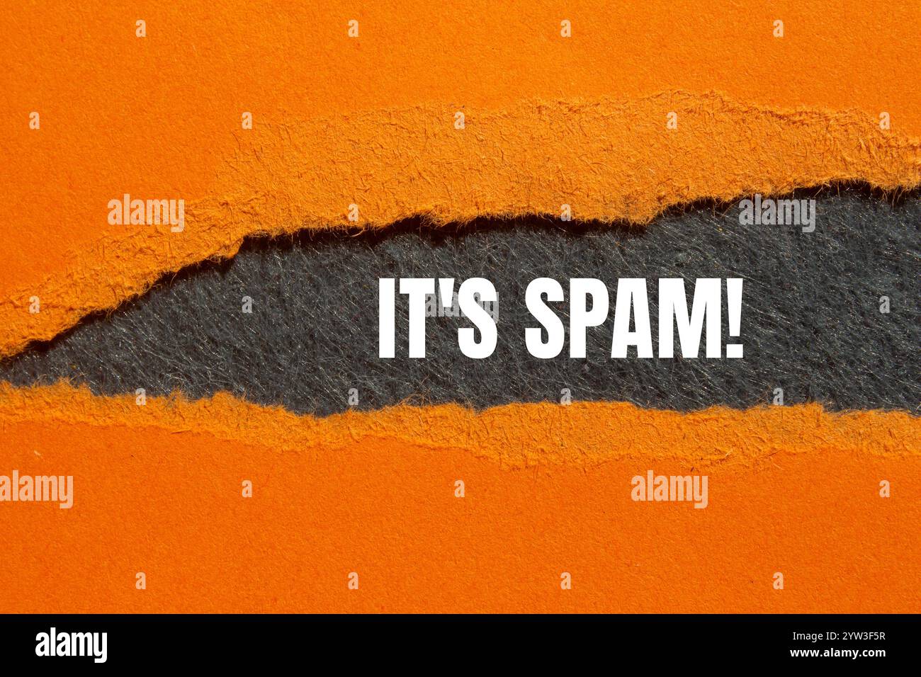 Es ist eine Spam-Nachricht, geschrieben auf gerissenem, gerissenem orangefarbenem Papier mit grauem Hintergrund. Konzeptionell ist das Spam-Symbol. Kopierbereich. Stockfoto